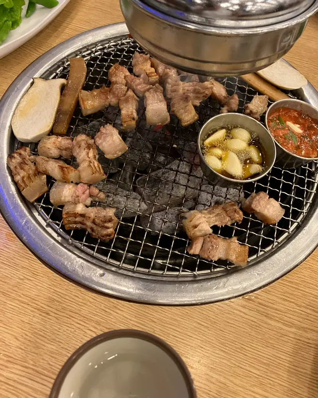 숯불 위에서 노릇하게 익어가는 흑돼지