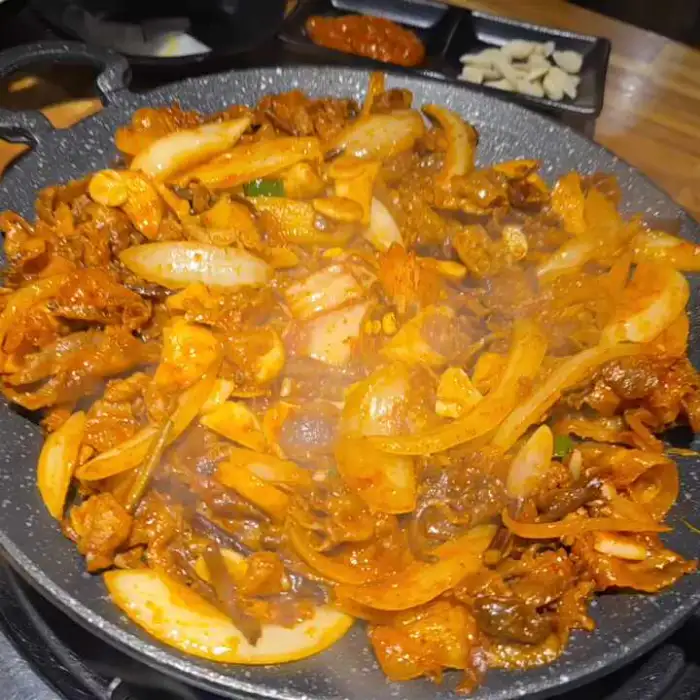 고추장 양념에 볶아진 대패삼겹살과 양파, 버섯 등의 모습