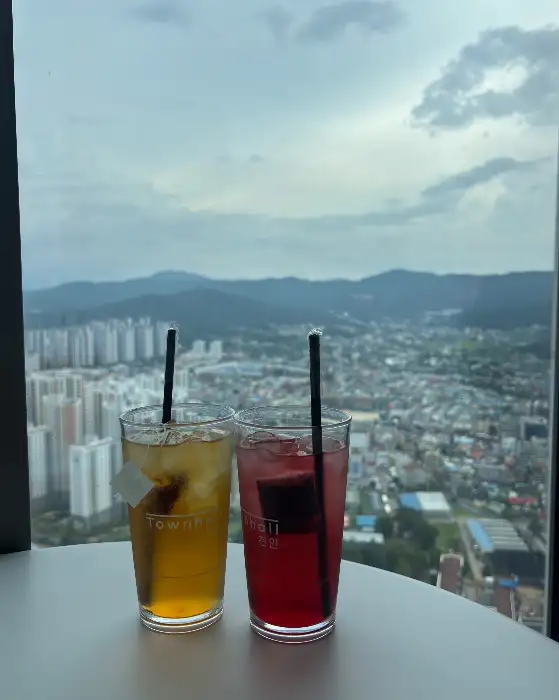 창밖 풍경과 함께 놓인 두 잔의 음료