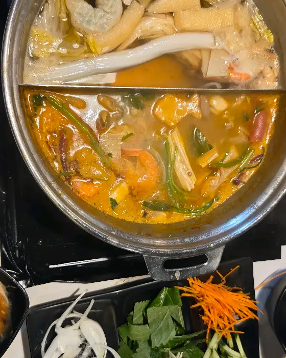 끓고 있는 육수에 소고기와 채소를 넣는 모습