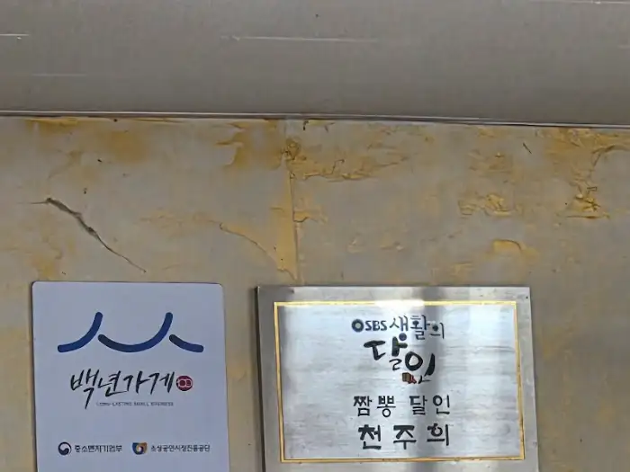 가게 벽에 걸린 메뉴판과 인증패