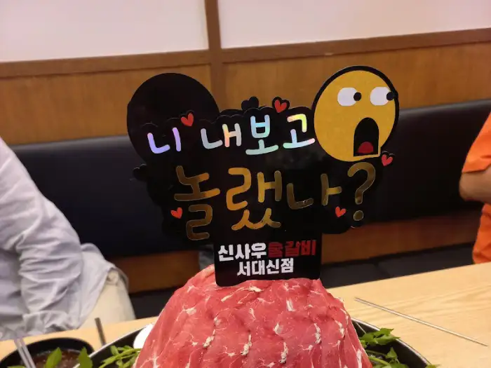우물갈비 위에 꽂혀 있는 재미있는 문구의 입간판