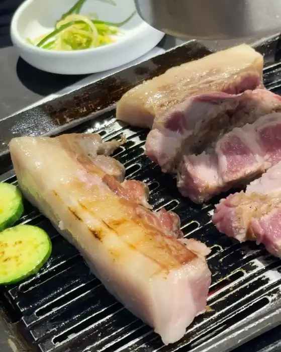숯불 위에서 맛있게 구워진 흑돼지 삼겹살