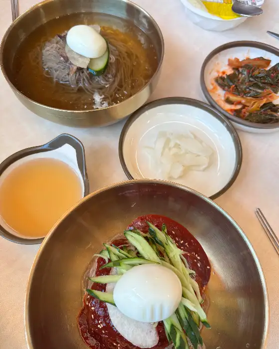 평양냉면과 갓김치, 그리고 물김치 등이 함께 놓여 있는 테이블 모습
