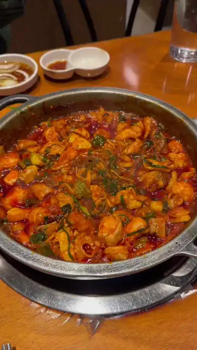 푸짐한 곱창전골이 끓고 있는 모습입니다. 빨간 국물에 채소와 곱창이 가득 들어있습니다.