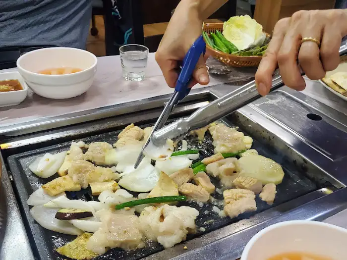 가위와 집게로 양곱창을 자르고 굽는 손길