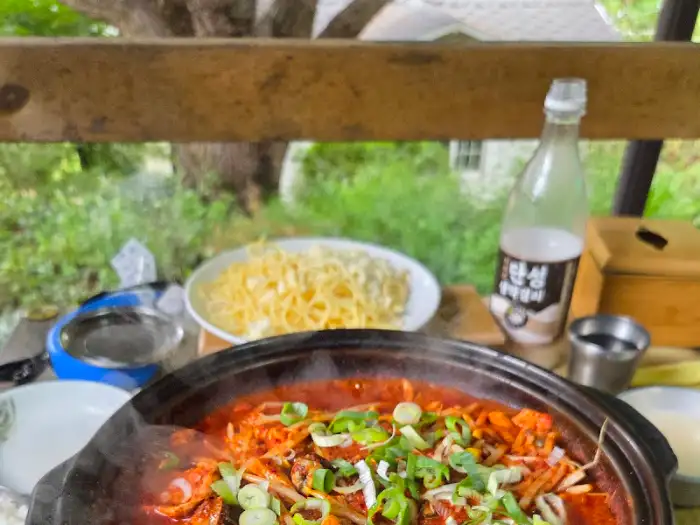 주문한 메인 요리 중 하나로 보이는 음식과 술병
