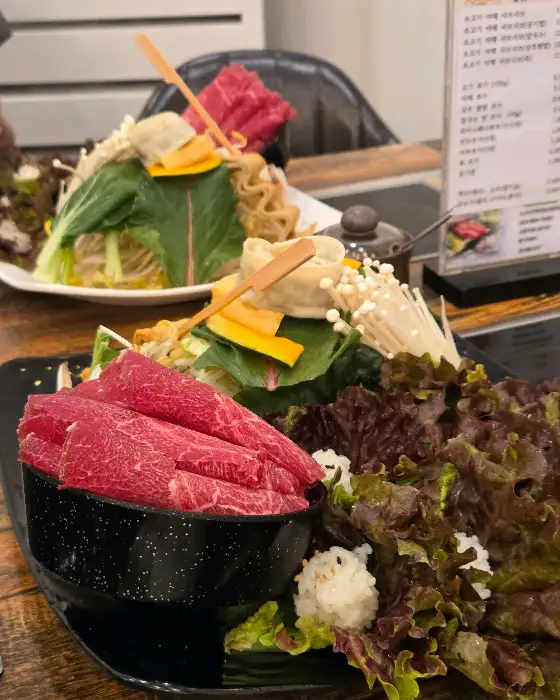다양한 채소와 신선한 고기가 푸짐하게 담긴 1인 샤브샤브 한상