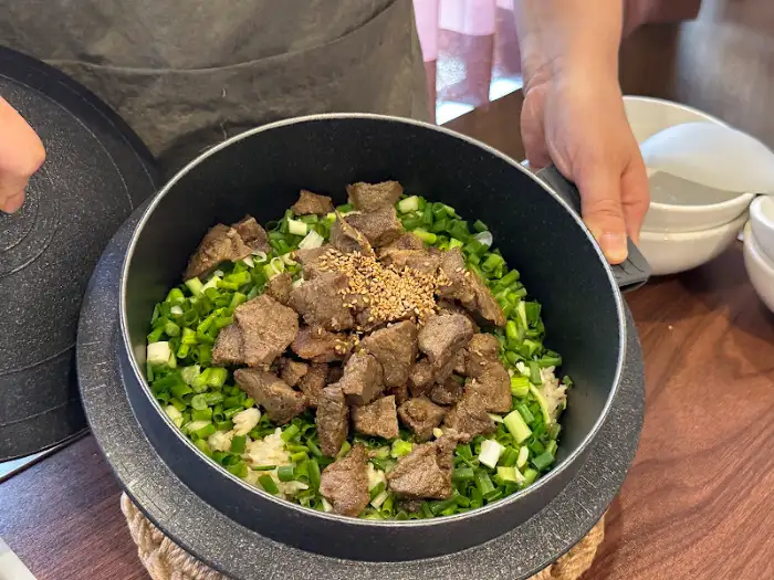돌솥밥 위에 푸짐하게 올라간 고기 토핑과 파채