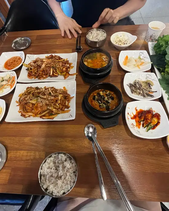 다양한 쌈 채소와 메인 요리가 정갈하게 차려진 촌아저씨쌈밥 문경본점의 한상차림