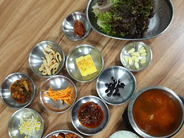 테이블 위 다양한 밑반찬들과 찌개