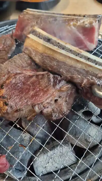 두툼한 갈빗대가 붙은 LA 갈비가 숯불 위에서 익고 있는 모습